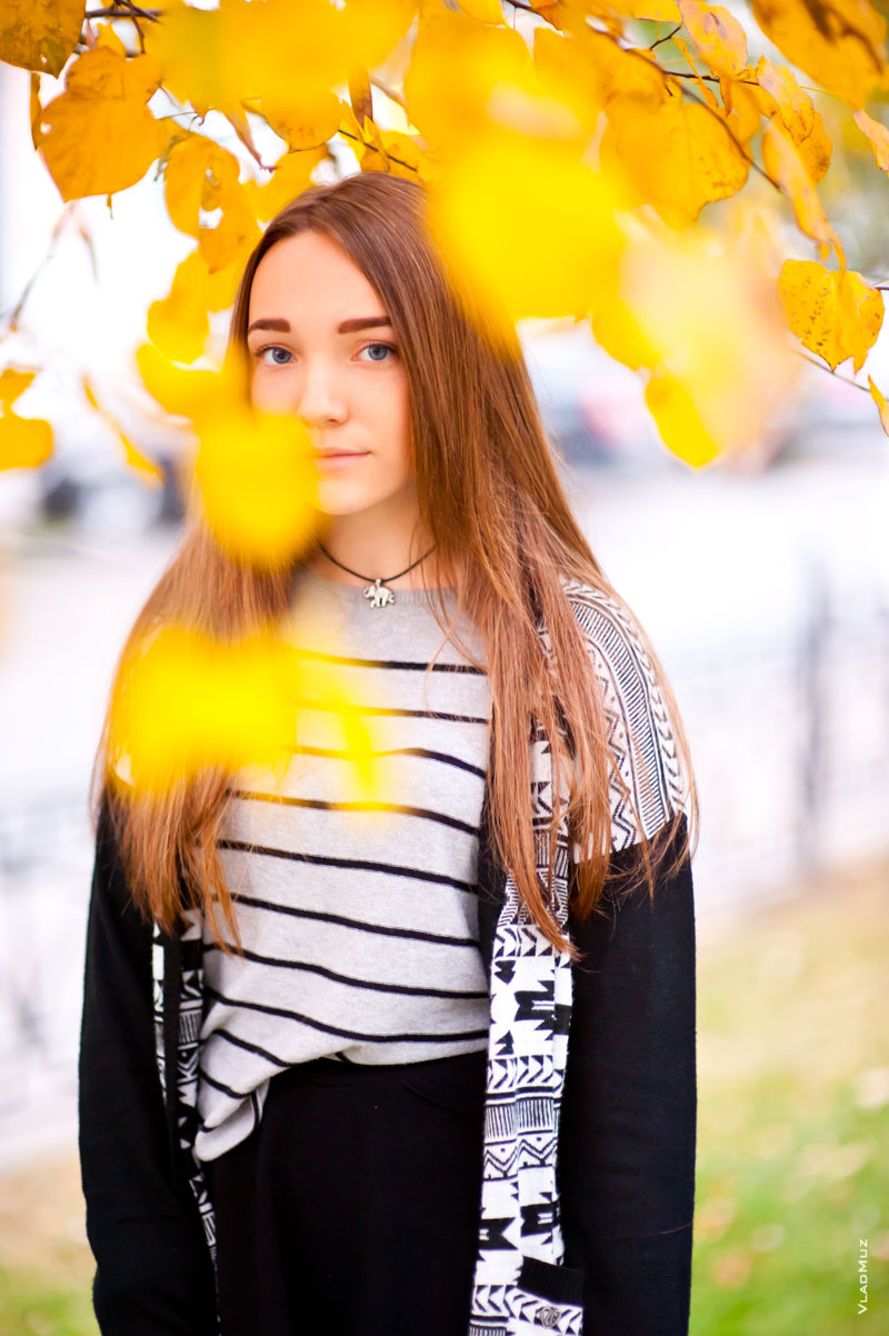 Осенний фотопортрет девушки среди желтых листьев в светлых тонах