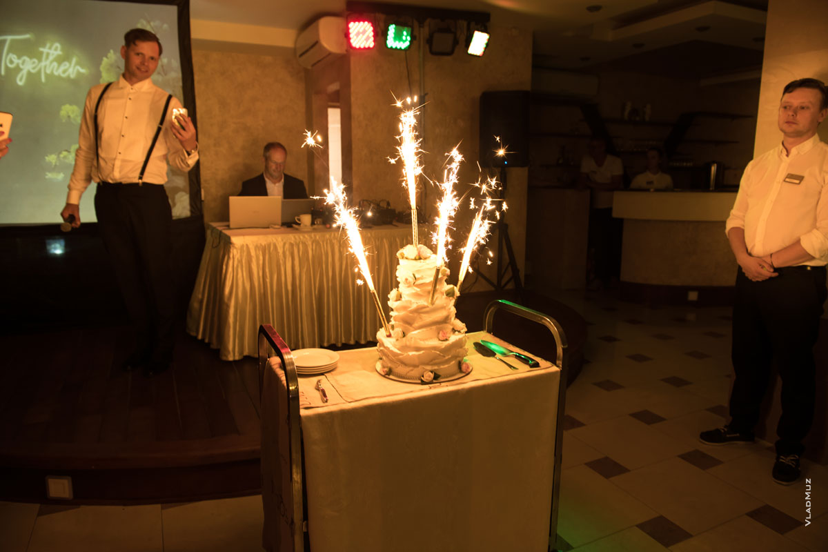 Фото свадебного торта в свете фонтанов горящих бенгальских свечей