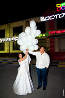 Фото жениха и невесты в финале свадебного вечера с воздушными шарами на улице